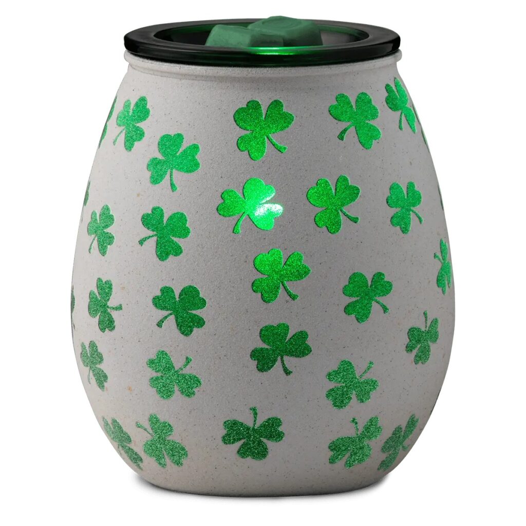 Scentsy clover warmer on in a light room.  With beautiful green clovers all over on a white background