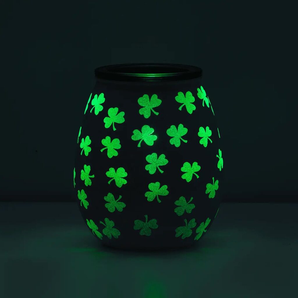 Scentsy clover warmer on in a dark room.  Beautiful green glow