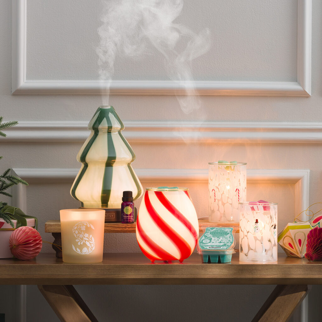 The full Scentsy Contemporary Christmas Collection featuring the Pine Swirl Diffuser, Peppermint Swirl Warmer, and Confetti Glass Warmers. A modern holiday setup glowing with red, green, and peppermint-striped charm.