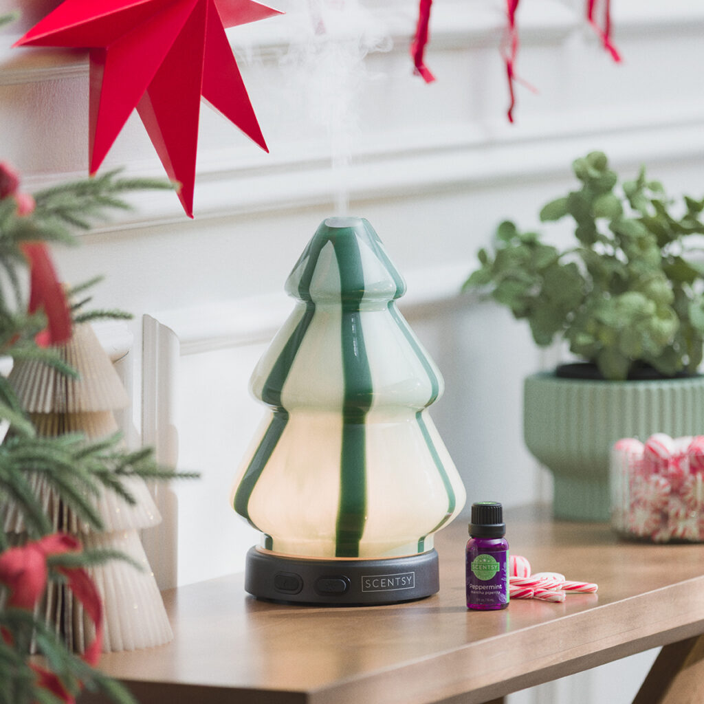 Scentsy Pine Swirl Diffuser shaped like a modern glass Christmas tree with green and white swirls. Features color-changing light modes for a festive glow and pairs perfectly with holiday essential oils.