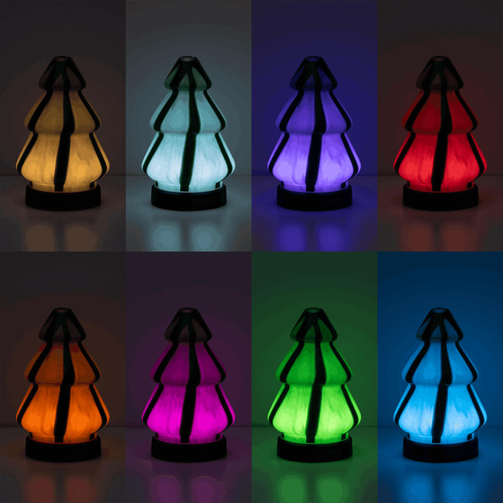 Scentsy Pine Swirl Diffuser shown in the dark with eight color modes—warm white, aqua, purple, red, amber, pink, green, and blue—modern glass Christmas tree design from the Contemporary Christmas Collection.”