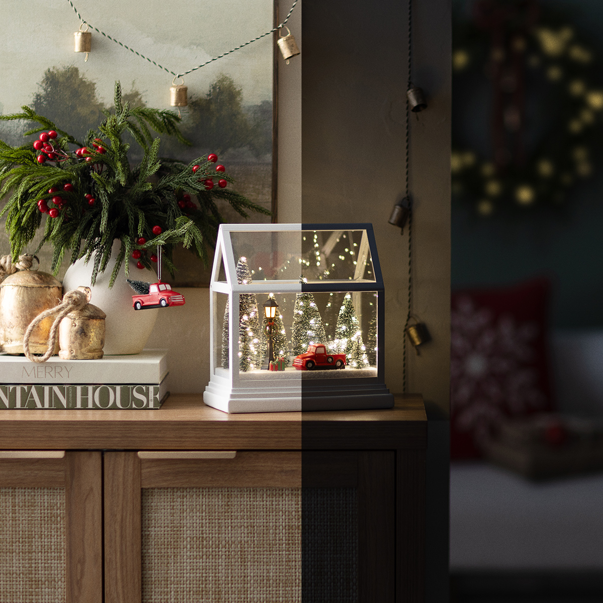 Side-by-side look at the Dashing Through the Pines Limited Edition Holiday Warmer by Scentsy shown in daylight and nighttime. The glass house design transforms with twinkling lights and festive Christmas charm.