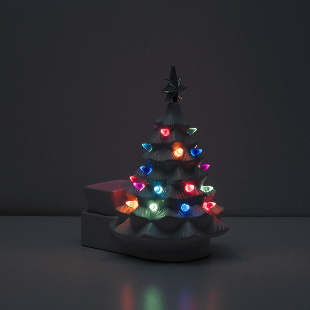 The Merry Little Christmas in white by Scentsy shining with colorful lights and silver star topper — giving classic Christmas tree magic and festive home fragrance vibes.
