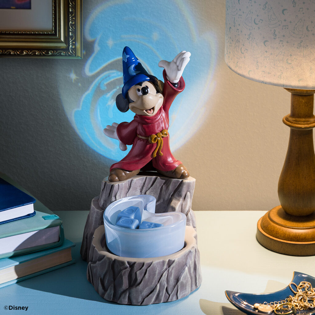 Disney Fantasia Sorcerer’s Apprentice Scentsy Warmer showing Mickey casting a spell, with glowing blue light projected onto the wall.