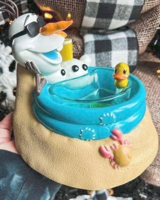 Disney Olaf at the Beach Scentsy Warmer featuring Olaf lounging in the sand with sunglasses, drink in hand, and a rubber duck floaty.