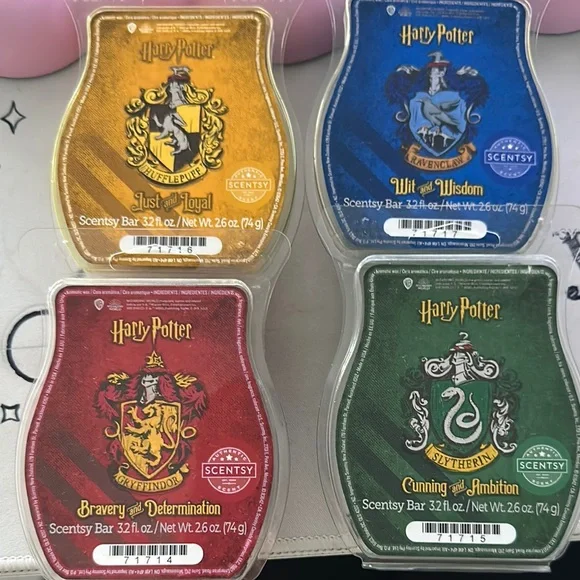 Harry Potter Scentsy wax bars inspired by the four Hogwarts houses: Gryffindor, Hufflepuff, Ravenclaw, and Slytherin, each with unique fragrance blends and colorful packaging.
