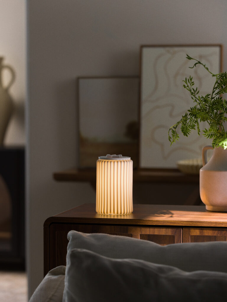Scentsy Fluted Glow Warmer from the Inspire Collection with soft vertical ridges and warm ambient light, perfect for a modern cozy space.