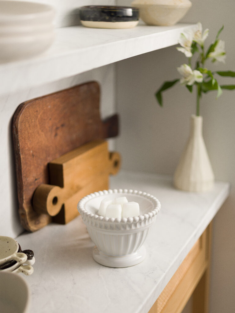 Scentsy Heirloom Warmer from the Inspire Collection, featuring geometric glass panels with a brass finish, creating an elegant and sophisticated glow.