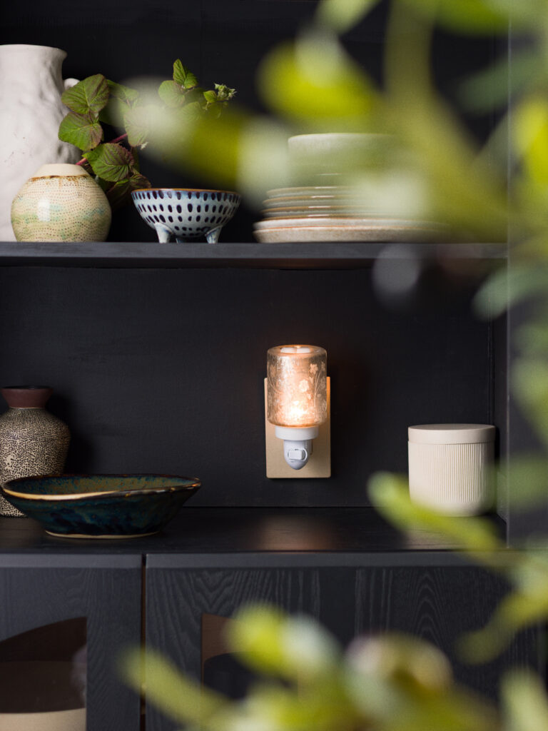 Scentsy Silver Stem Mini Warmer from the Inspire Collection with delicate floral etching, glowing softly against a neutral wall.”