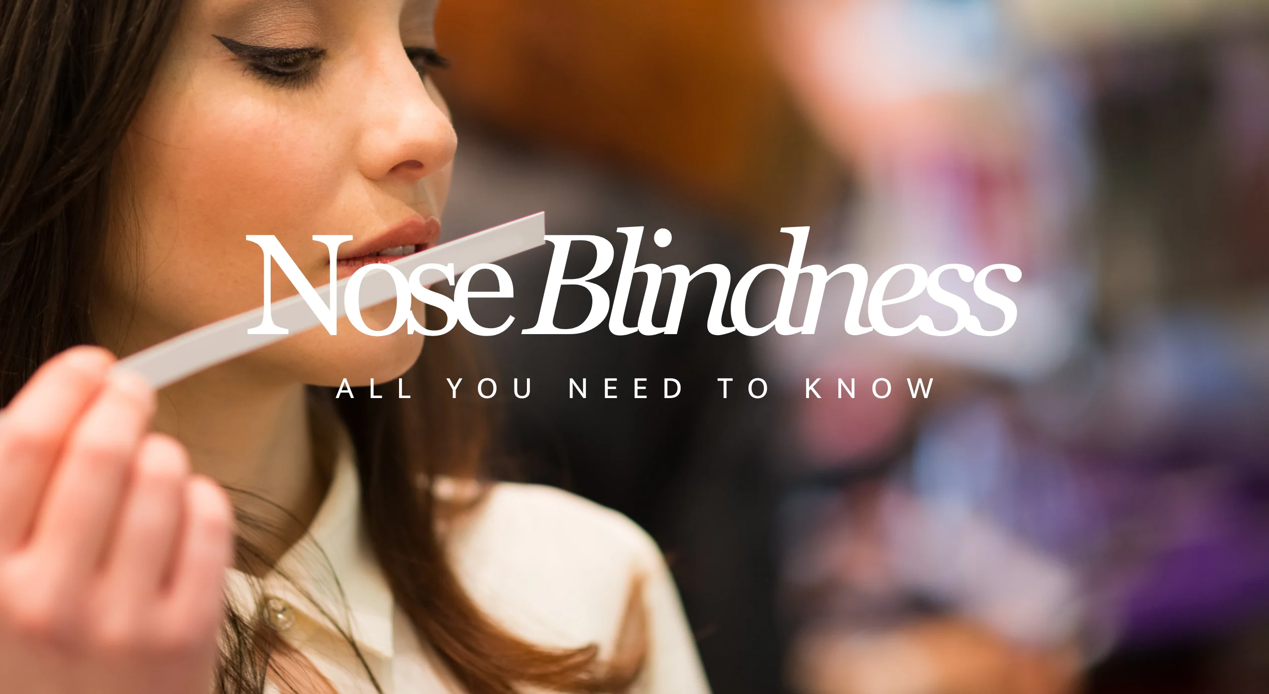 Person smelling a scent strip, representing nose blindness and how our sense of smell can become less noticeable over time.