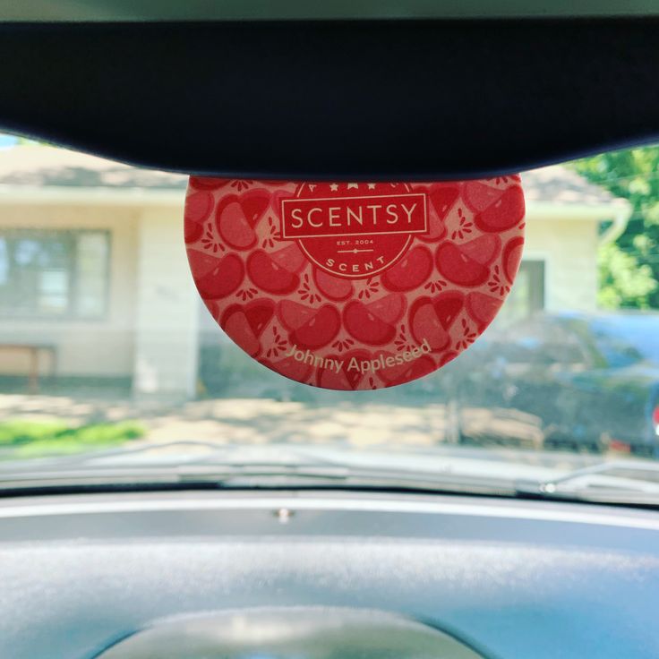 Scentsy Scent Circle hanging in a car, showing how scent circles are commonly used as an easy car air freshener.