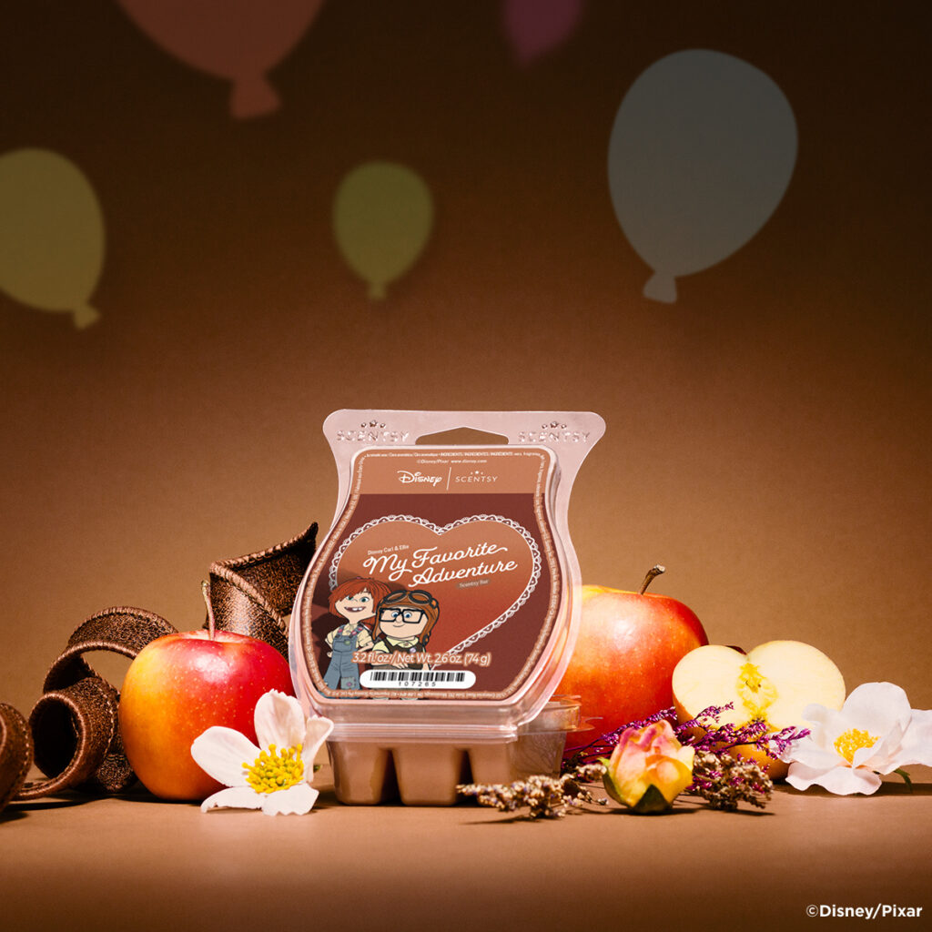 Disney Scentsy My Favorite Adventure wax bar inspired by Carl and Ellie from Up, styled with apples and florals in warm tones.