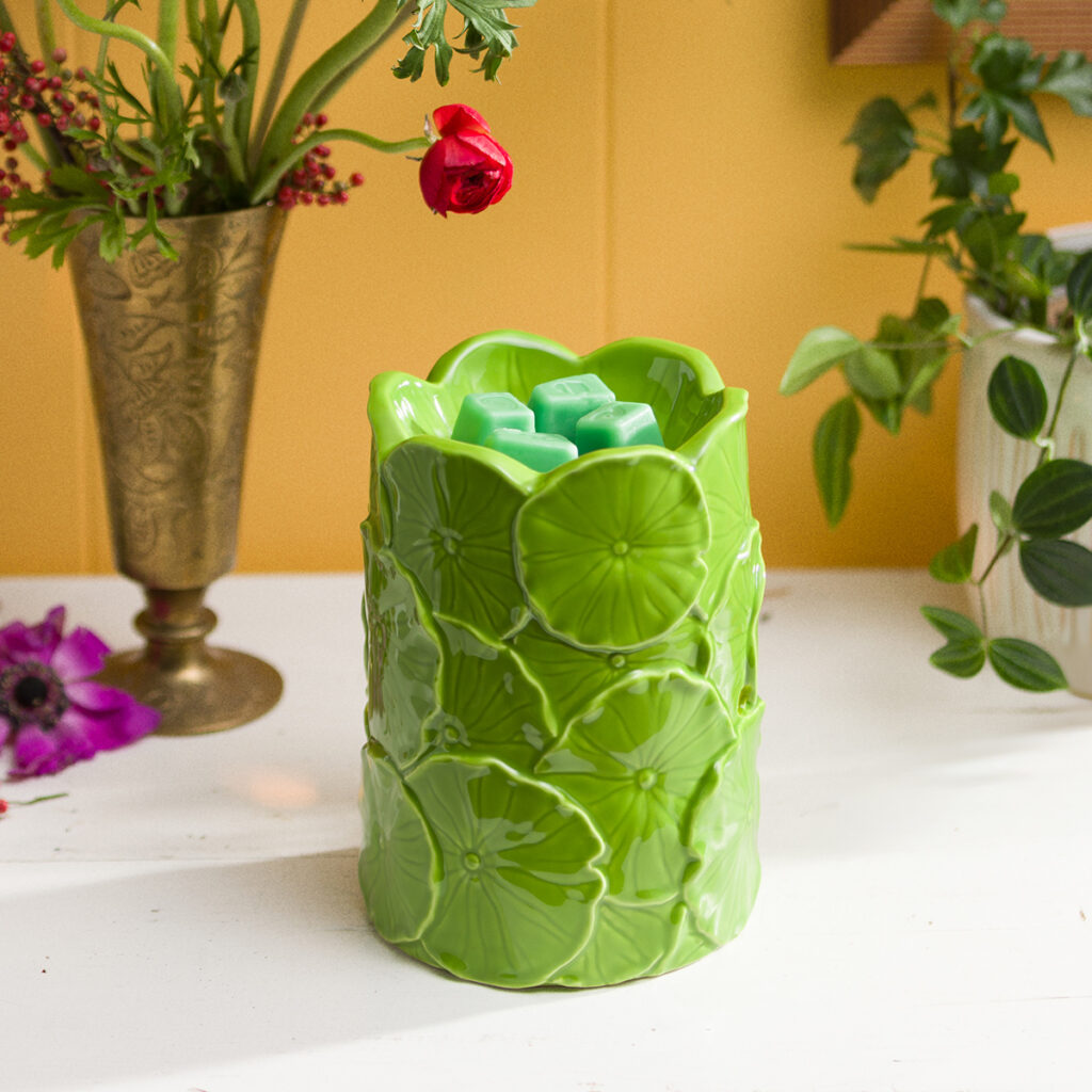 Leap & Lily Scentsy warmer with a raised leaf pattern in bright green, styled with wax cubes and fresh spring decor.