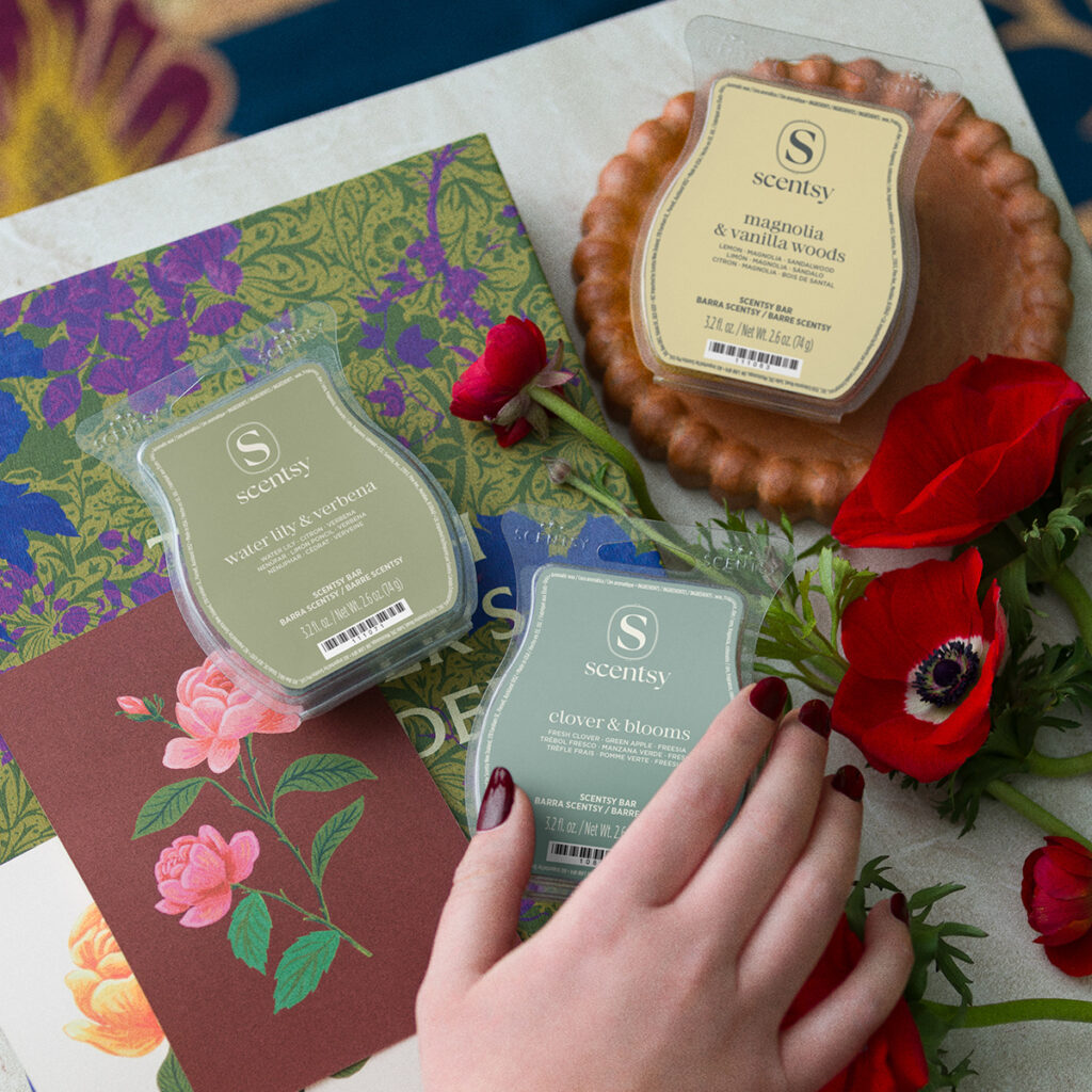 Scentsy March Edit garden-inspired wax bars featuring Clover & Blooms, Water Lily & Verbena, and Magnolia & Vanilla Woods scents styled with florals