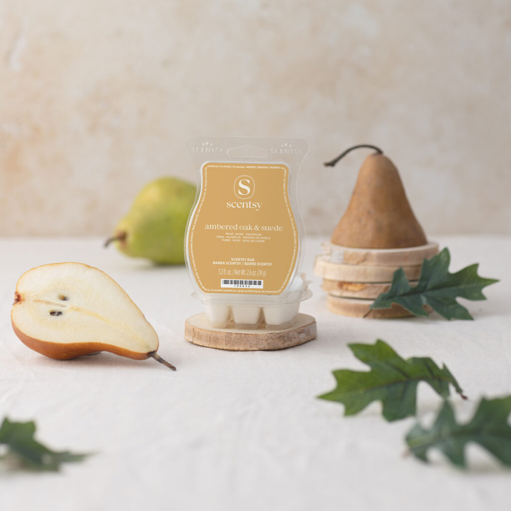 Scentsy Ambered Oak & Suede wax bar styled with pears and wood accents for a warm, cozy vibe.