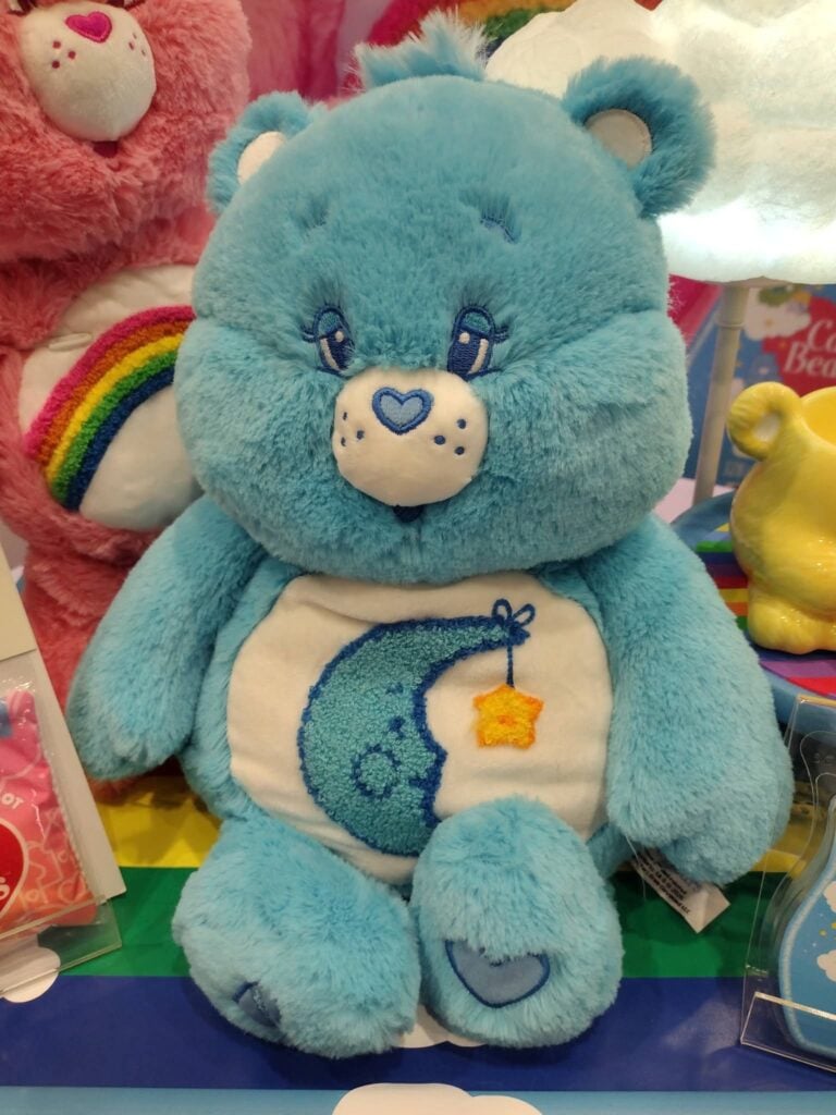 Scentsy Care Bears Bedtime Bear, a blue weighted and warming plush featuring a moon and hanging star on his belly.