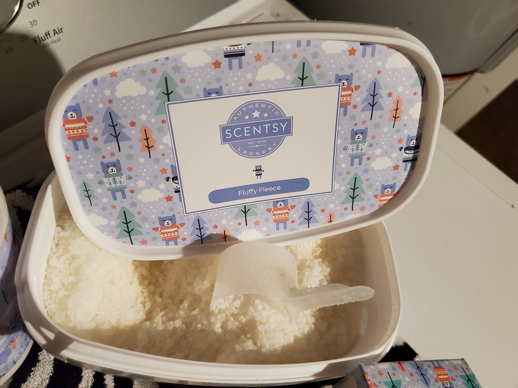 Scentsy Fluffy Fleece Washer Whiffs with measuring scoop for adding long-lasting fragrance to laundry.