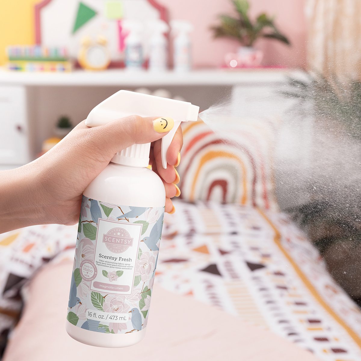 Scentsy Fresh fabric spray in Magnolia Linen being sprayed onto a couch to eliminate odors and freshen upholstery.