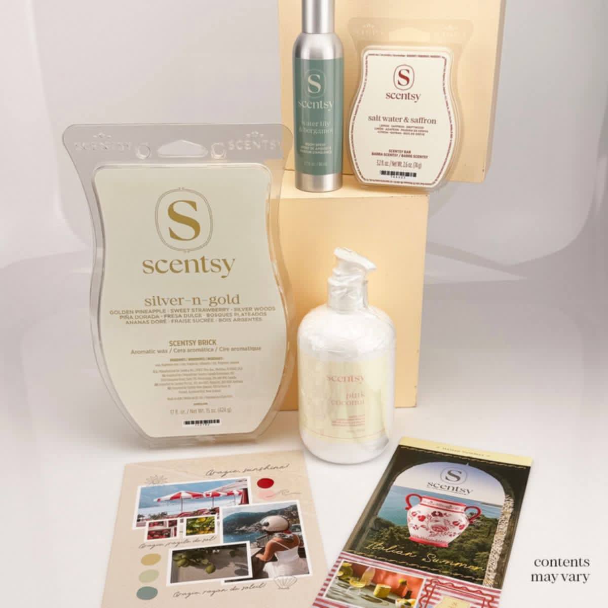 July Scentsy Whiff Box featuring a Silver N Gold Scentsy Brick, Salt Water & Saffron Scentsy Bar, Water Lily & Bergamot Room Spray, Pink Coconut Hand Soap, and the Italian Summer promotional brochure. Contents may vary.