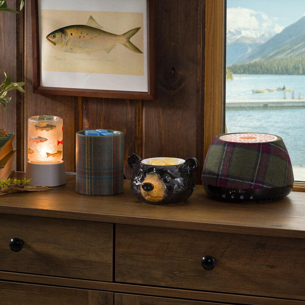 August 2026 Scentsy Cozy Cabin Edit featuring the Blackwood Bear Warmer, Elmwood Warmer, Silver Fins Mini Warmer, Plaid Scentsy Air Quad, and Sutton the Scottie Dog Scentsy Buddy.