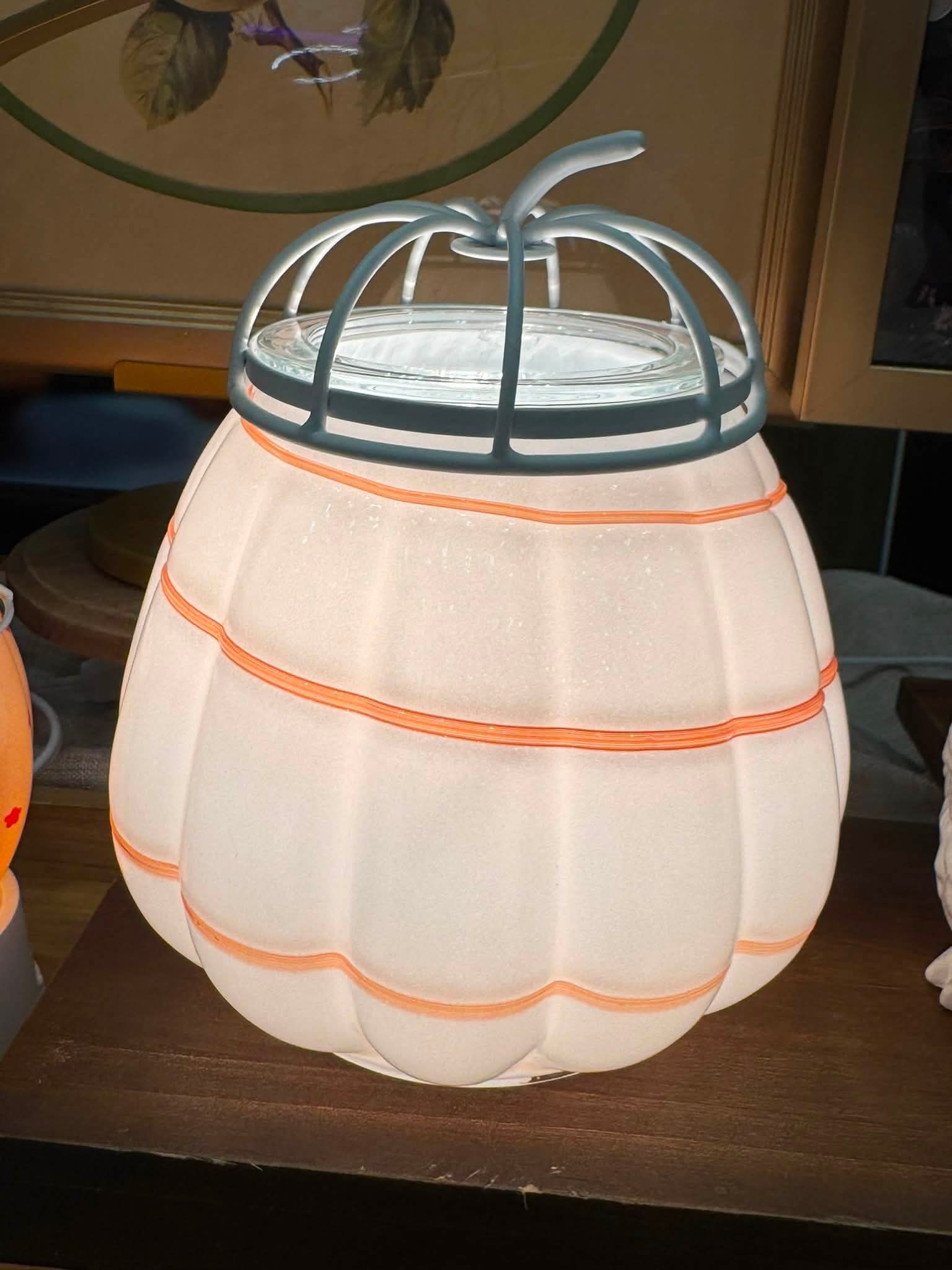 White pumpkin, cider swirl Scentsy Warmer with glowing orange accent lines and a white metal pumpkin stem.