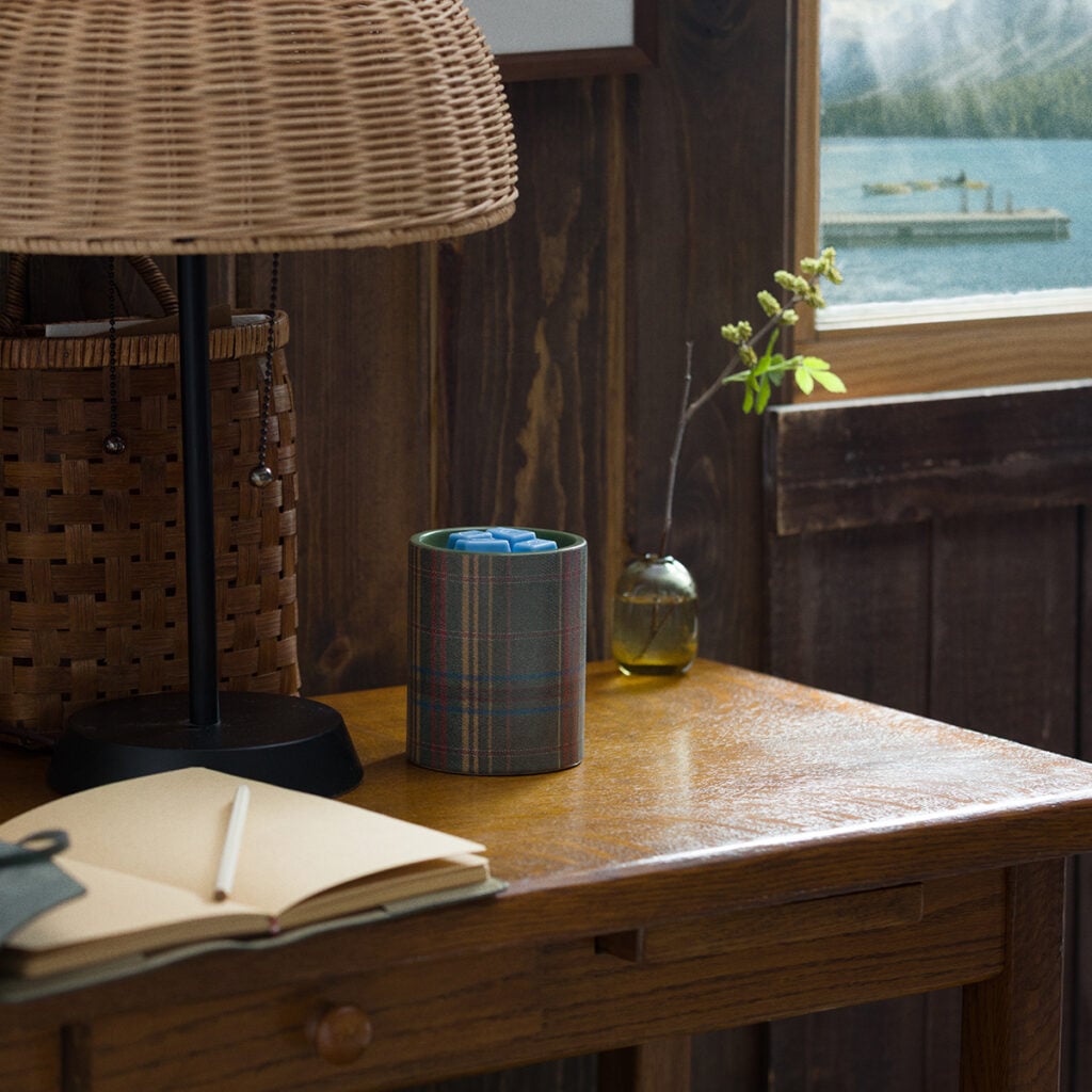 Elmwood Scentsy Warmer with a green plaid fabric-inspired design holding blue wax cubes from the August 2026 Cozy Cabin Edit.