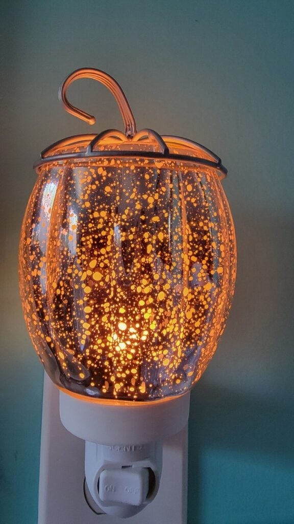 Amber mercury glass pumpkin Scentsy Mini Warmer, Fall Fairy Tale Pumpkin Mini scentsy warmer, glowing with a speckled glass finish and curled metal stem.