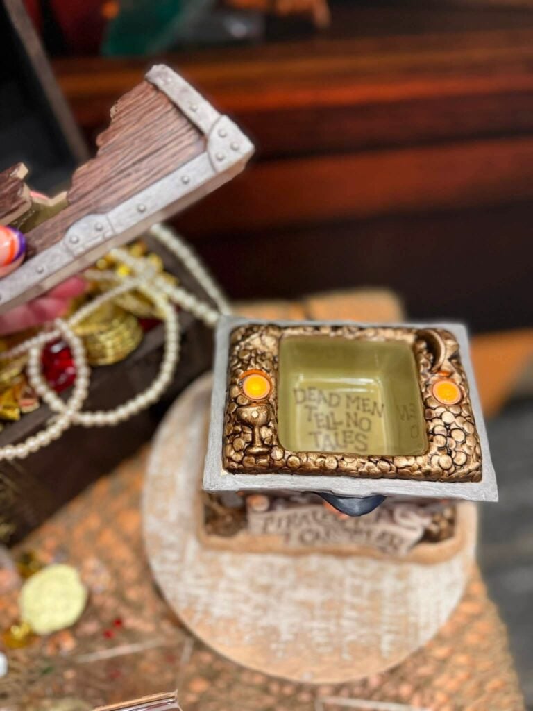 Inside the Disney Pirates of the Caribbean Scentsy warmer showing the removable wax dish with "Dead Men Tell No Tales" printed inside.