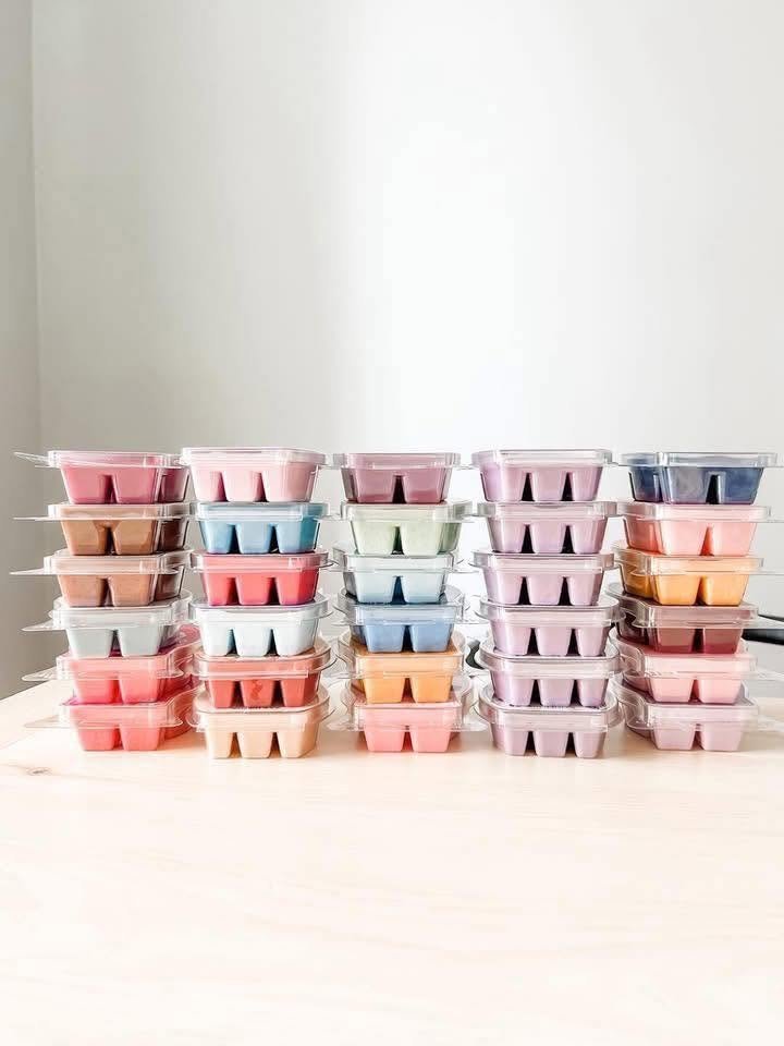 Collection of colorful Scentsy Wax Bars stacked in rows, showcasing a variety of fragrances and wax colors.