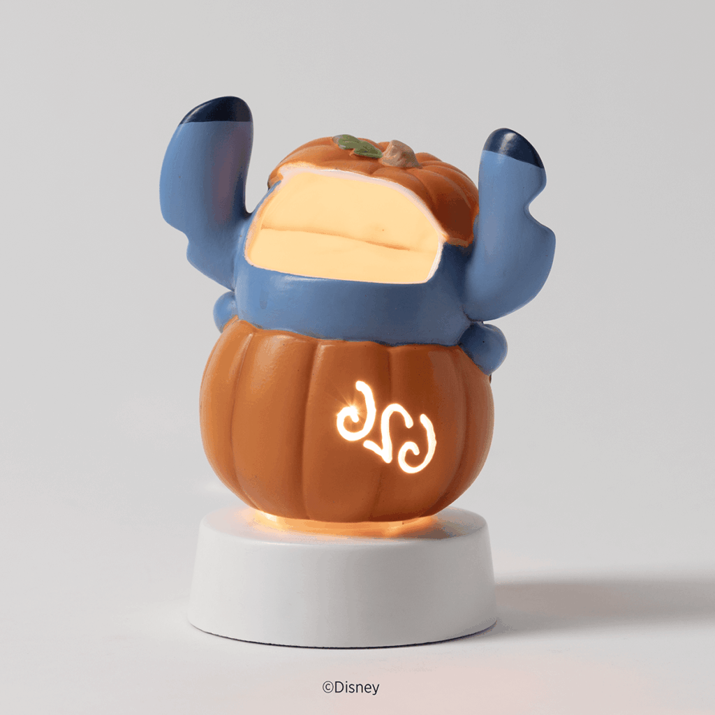 Back view of the Disney Stitch Pumpkin Trouble Scentsy Mini Warmer showing Stitch inside a pumpkin with a glowing cutout design.