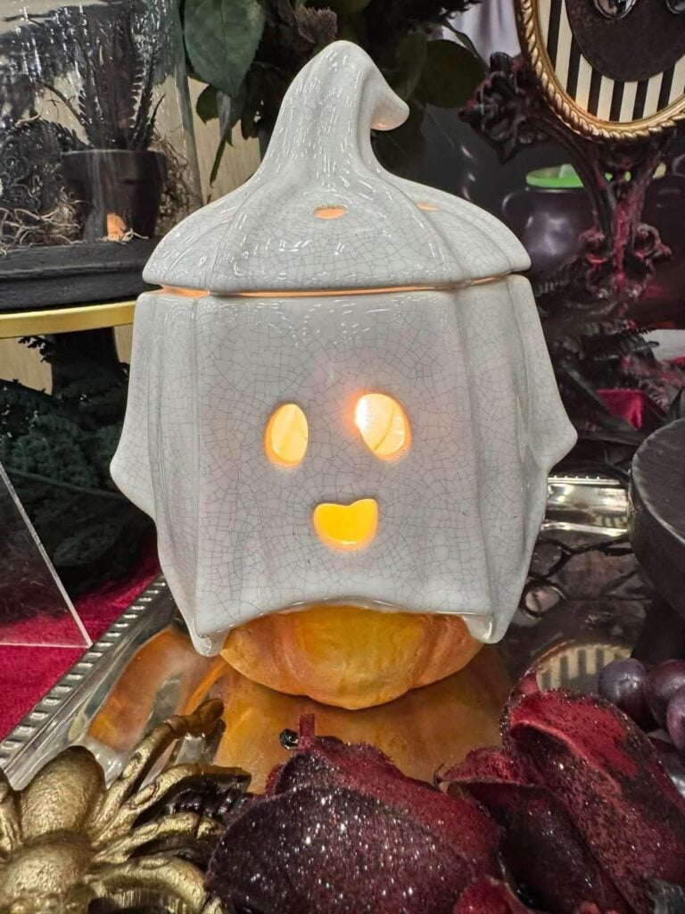 Ghostlight Gourd Scentsy Warmer featuring a smiling ghost draped over a pumpkin with a warm Halloween glow.