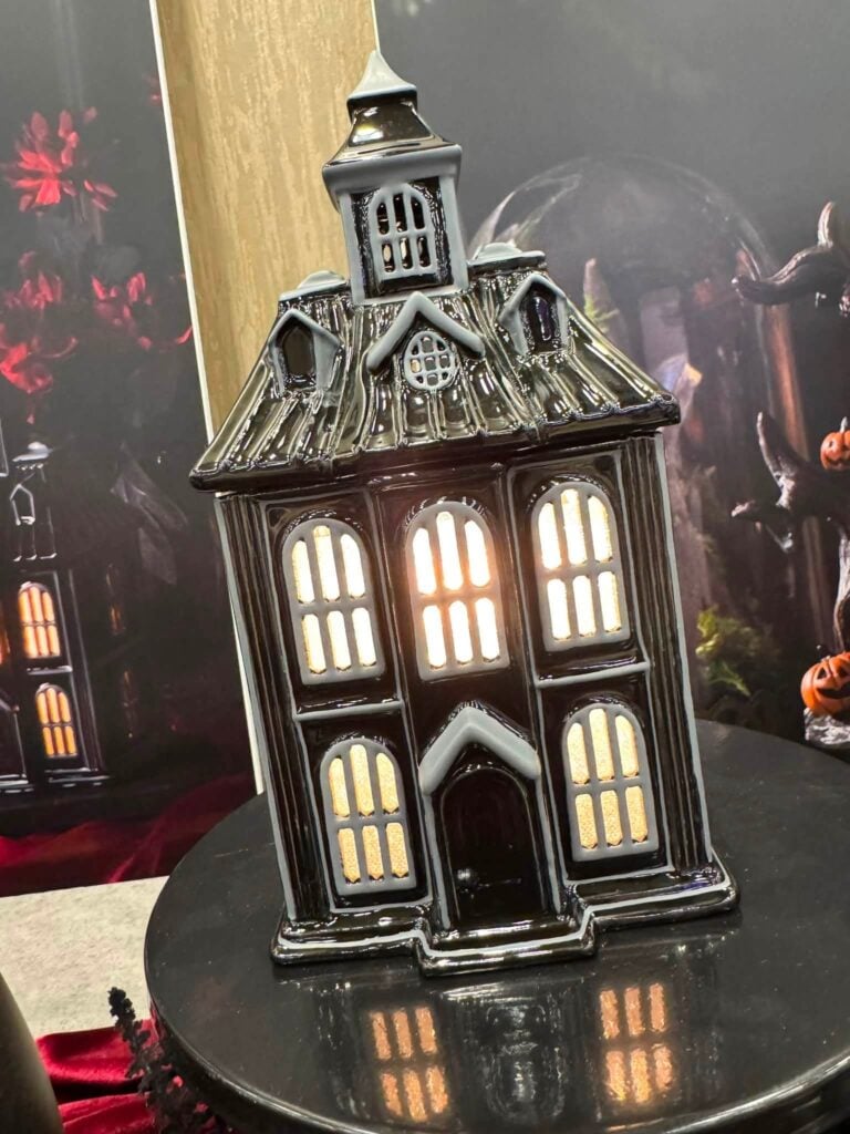 Haunted Haven Scentsy Warmer shaped like a spooky black haunted house with glowing windows.