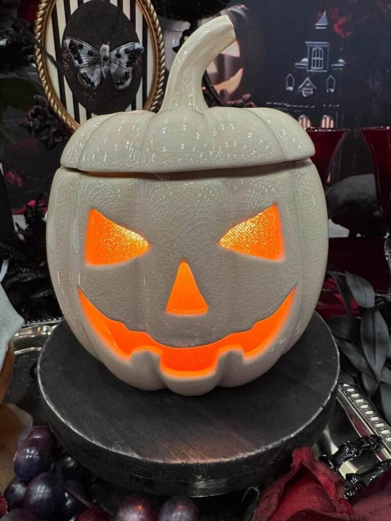 Jack's Glow Scentsy Warmer shaped like a glowing white jack-o'-lantern with an illuminated Halloween face.