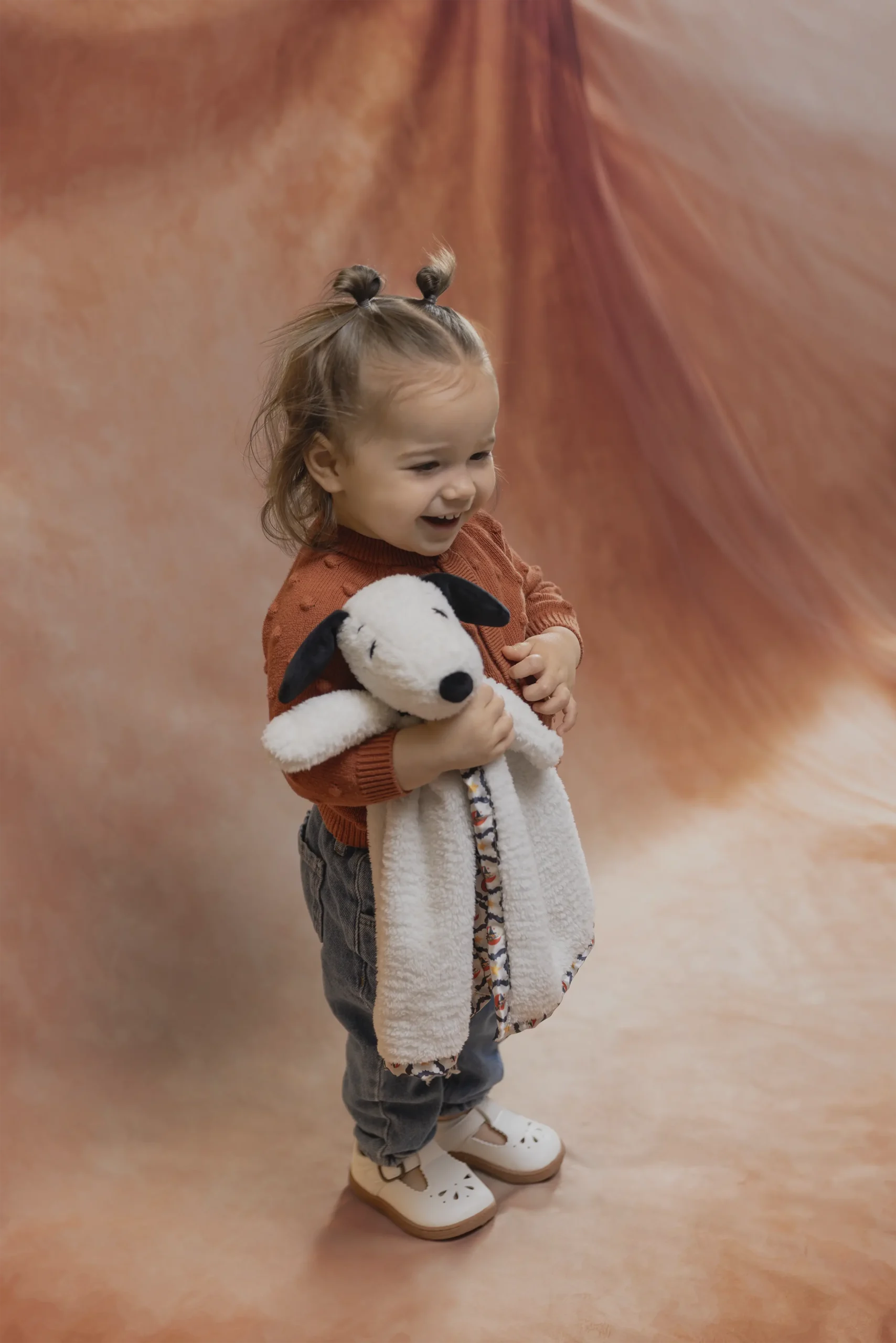 Child holding the Snoopy's Happy Halloween Blankie Buddy from the Scentsy Peanuts Collection.