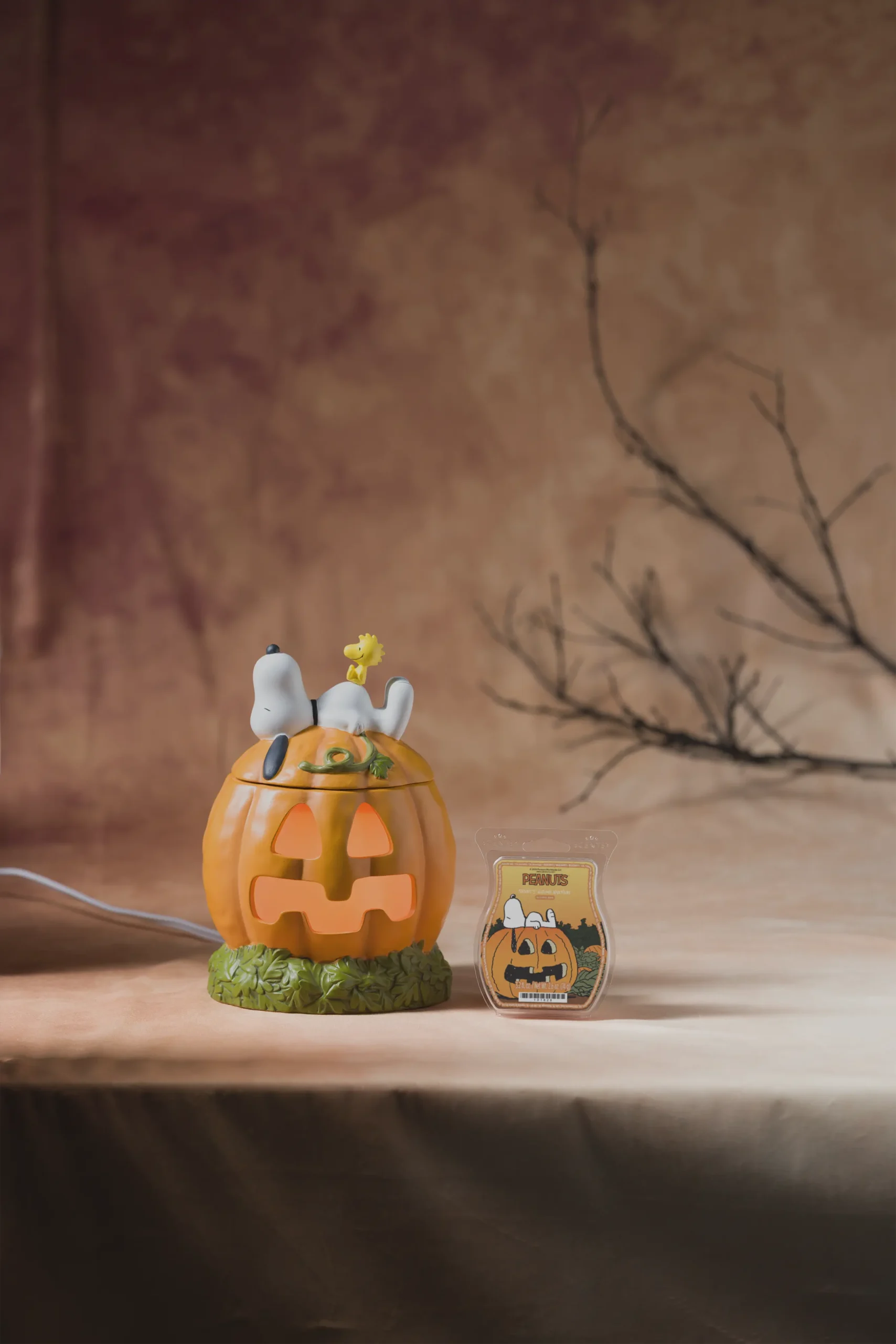 Snoopy's Pumpkin Patch Scentsy Warmer with the Snoopy's Autumn Adventure Scentsy Bar displayed beside it.