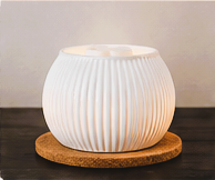 White fluted warmer on a cork coaster base