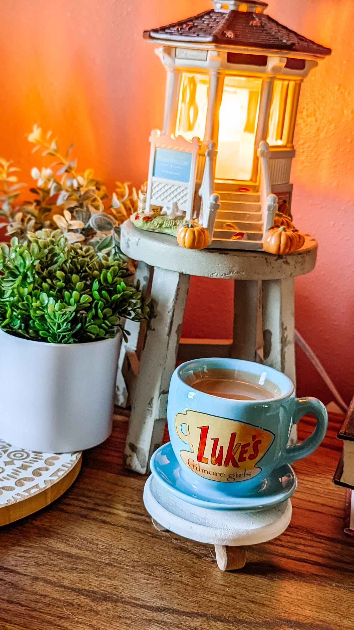 Gilmore Girls Welcome to Stars Hollow Scentsy Warmer glowing beside the Luke's Coffee Mug Mini Warmer in a home display.