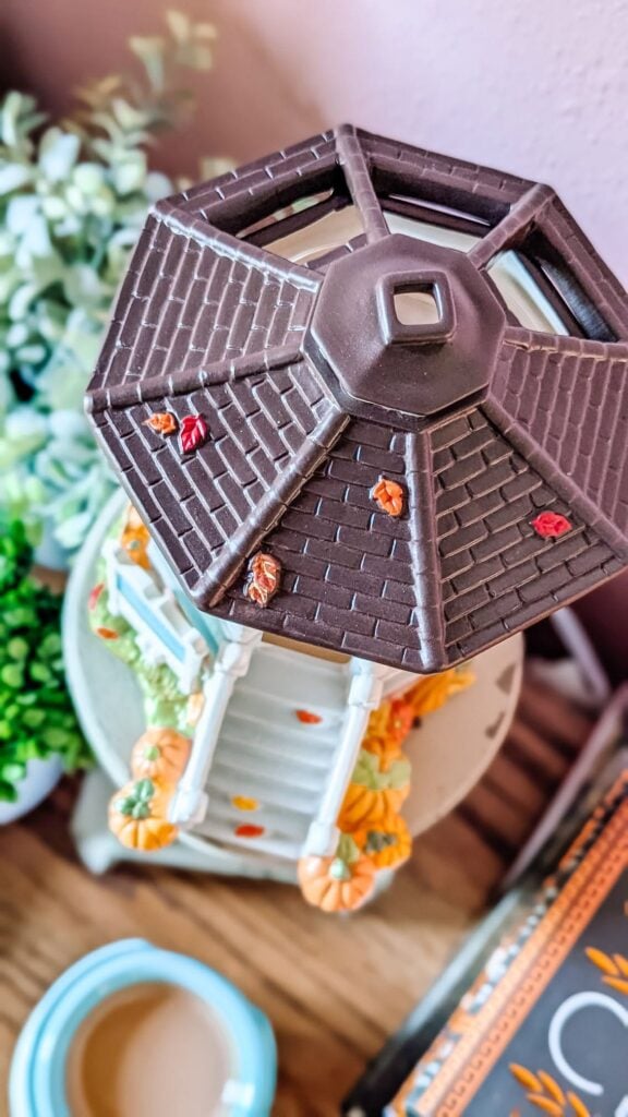 Close-up of the Welcome to Stars Hollow Scentsy Warmer roof with colorful fall leaves.