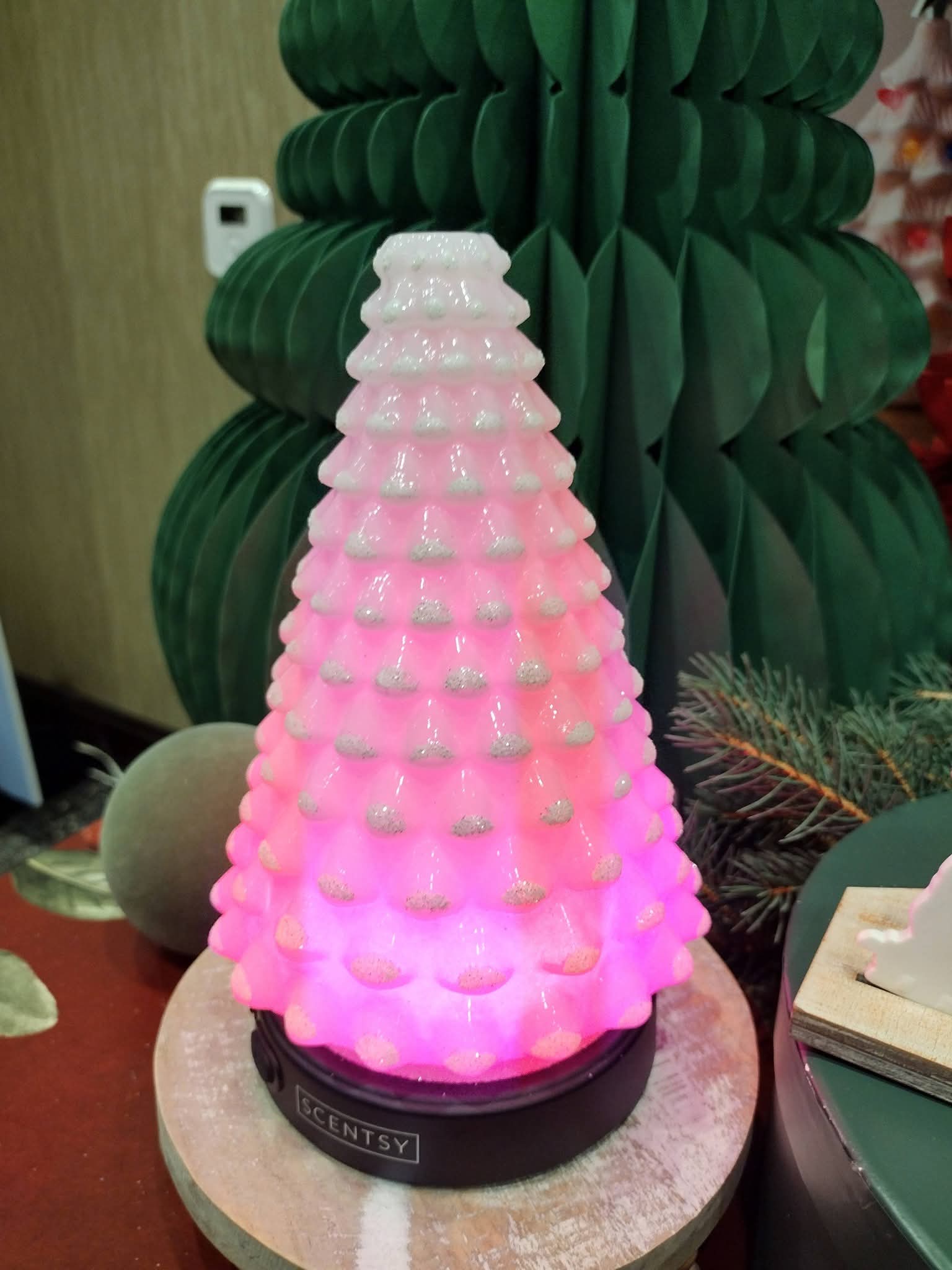 Scentsy Aura Frost Diffuser Shade shaped like a snowy Christmas tree and glowing pink.