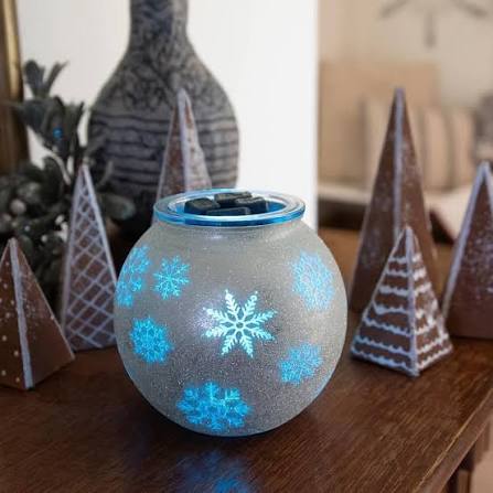 Scentsy Blue Frost Warmer glowing with blue and white snowflakes on a frosted round design.