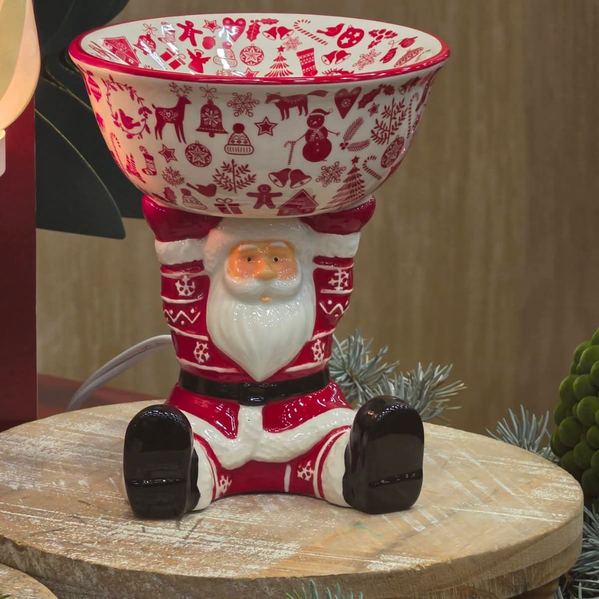 Scentsy Christmas Keeper Warmer featuring Santa holding a large red and white bowl decorated with Christmas designs.