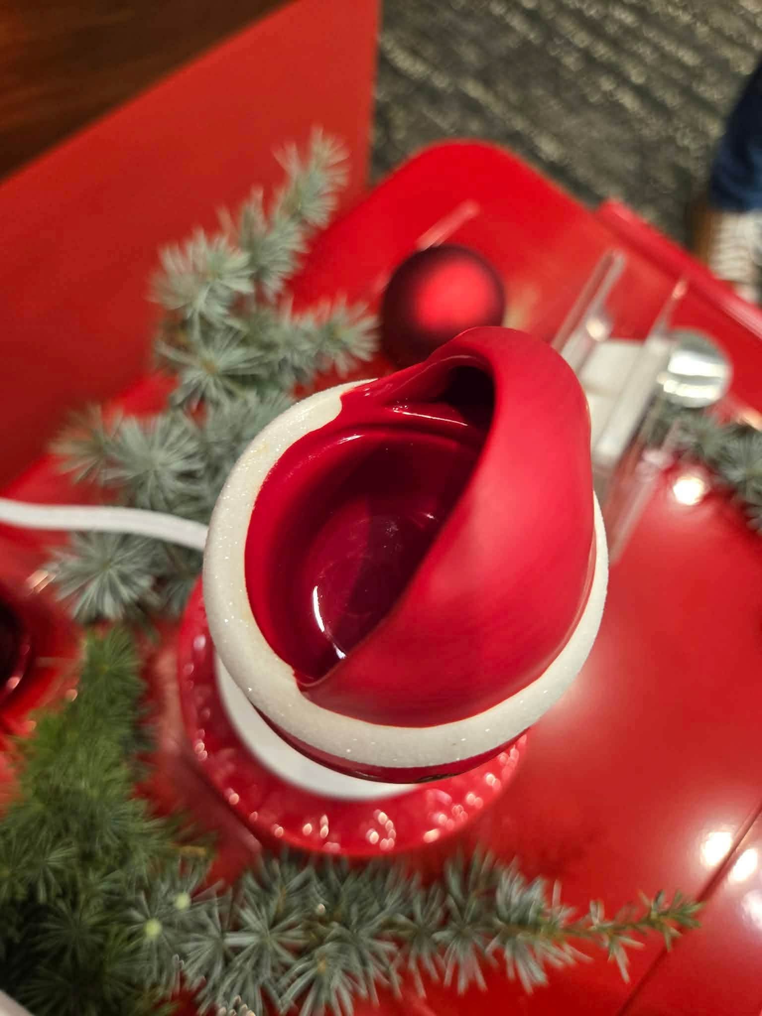 Top view of the Coca-Cola Sparkling Holidays Scentsy Mini Warmer showing the red wax dish inside Santa's hat.