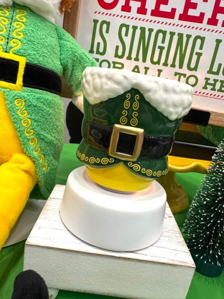 Elf Buddy's Christmas Joy Scentsy Warmer designed like Buddy's green coat with a black belt and snowy white trim