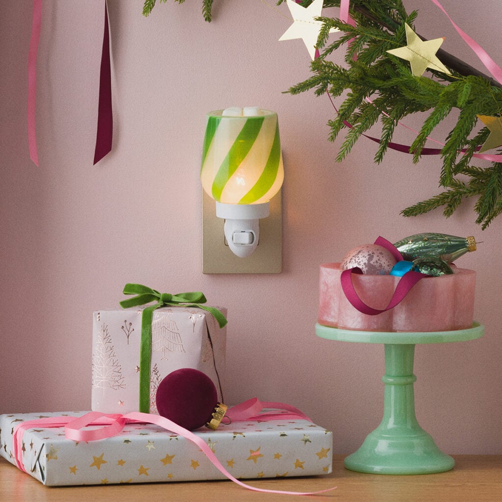 Scentsy Polar Mint Mini Warmer with green and white peppermint stripes, styled with Christmas gifts and holiday decorations