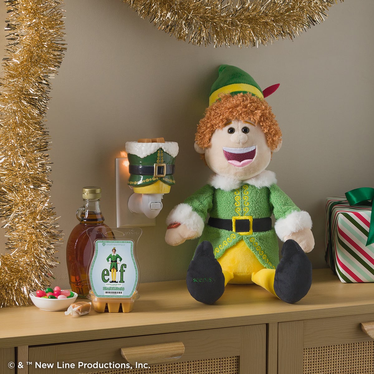 Warner Bros. Elf Scentsy holiday collection featuring the Buddy the Elf Scentsy Buddy and Elf-themed warmer.