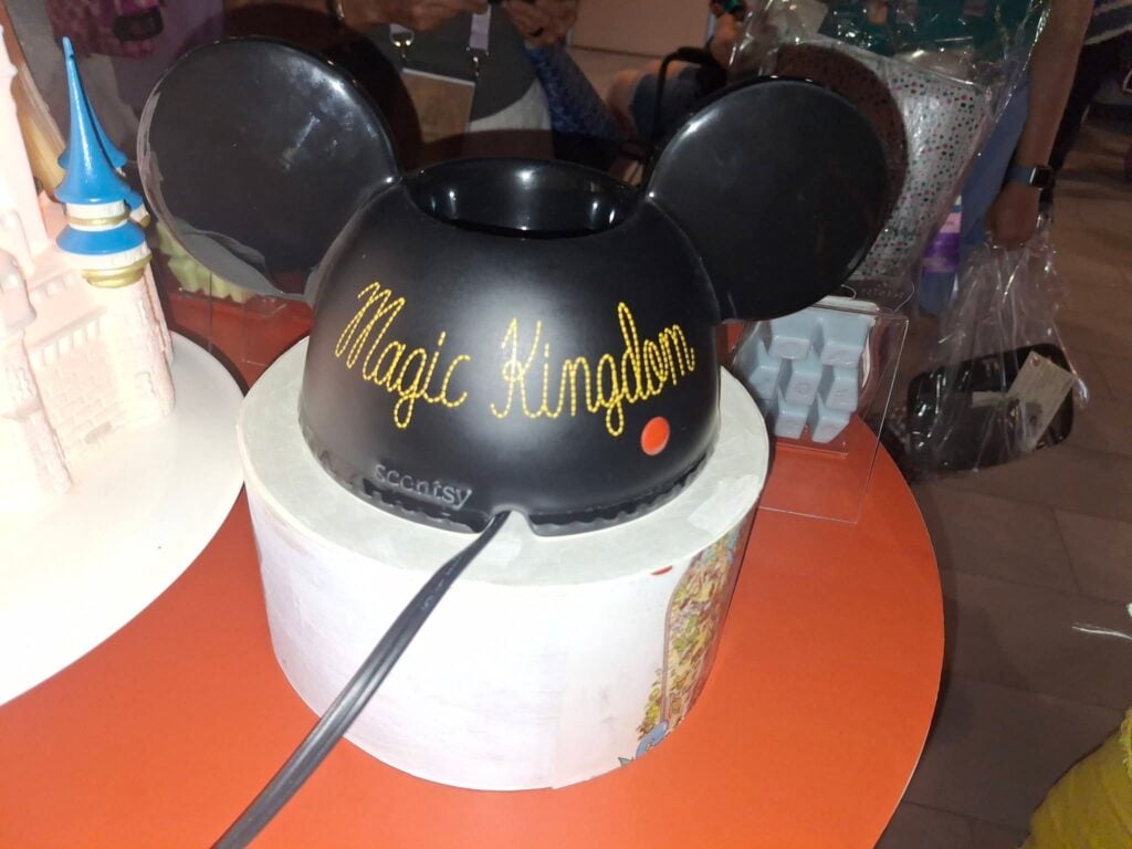 Walt Disney World Embroidered Mickey Ears Scentsy Warmer displayed in person with Magic Kingdom illuminated on the front.