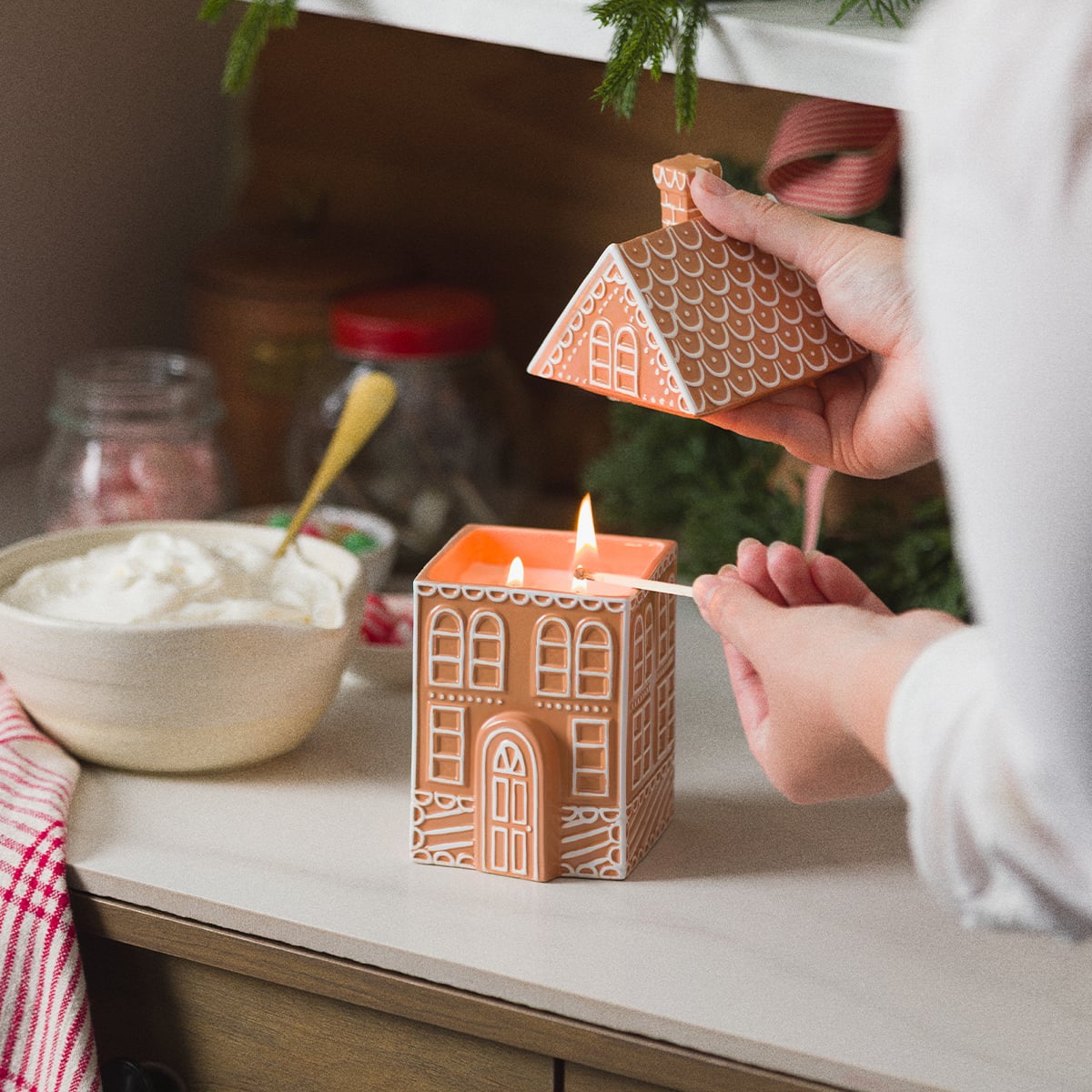 Whipped Frosting Scentsy scented candle designed like a gingerbread house with a removable roof.